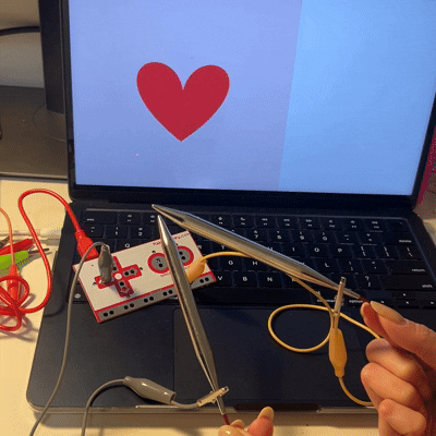 Having one alligator clip connected to one side of a needle and the other side connected to a arrow key makes a connection when touched together