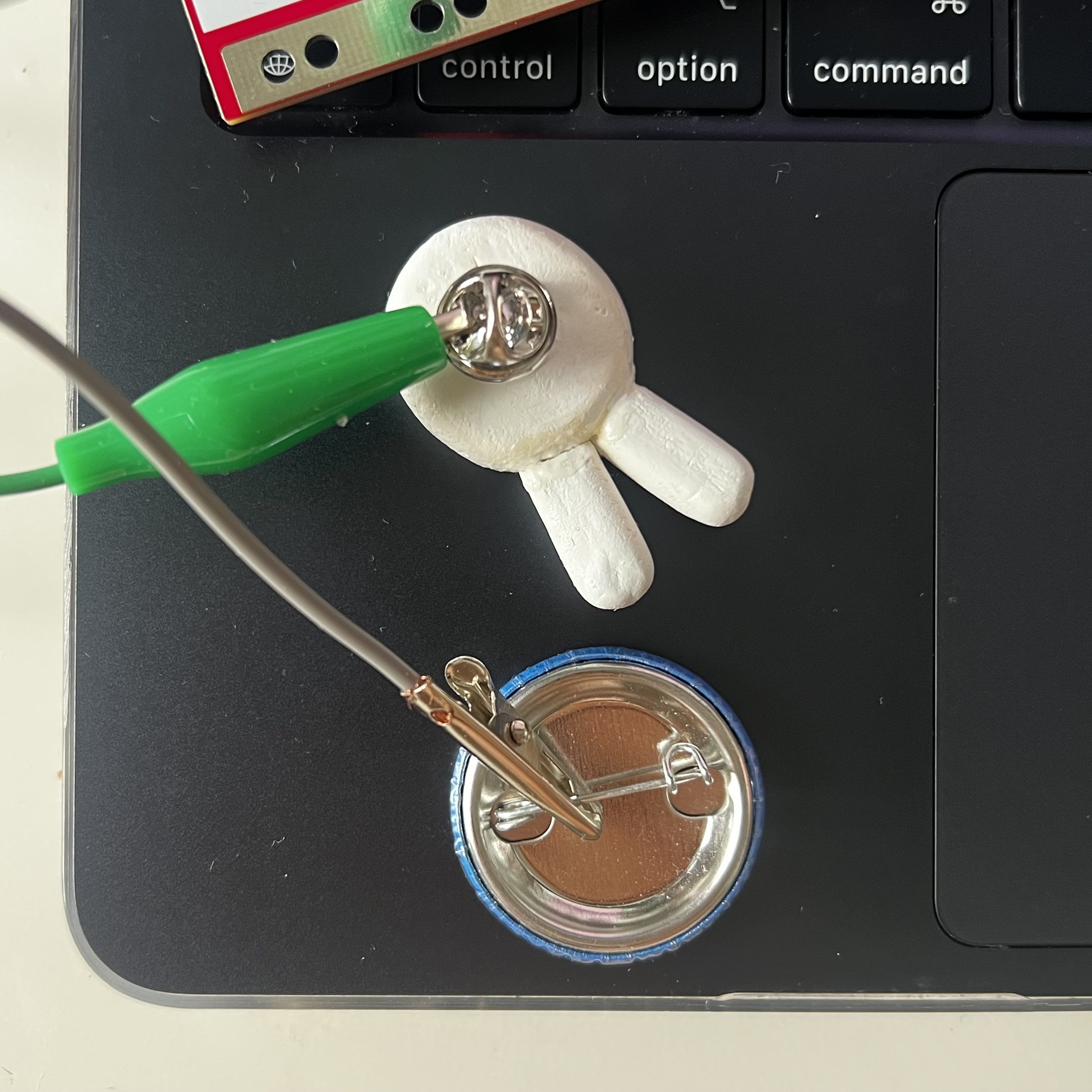 Using the metal clip of pins as buttons